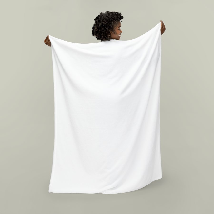 Person holding up a blank white plush blanket